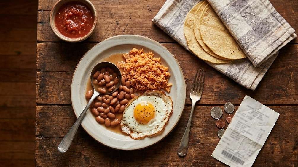 Beans, red rice, corn tortillas, salsa and a fried egg: the $1.28 plate, photographed for the book